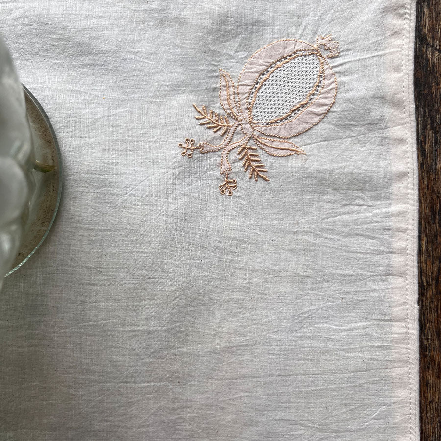 Embroidered pomegranate motif on muslin fabric