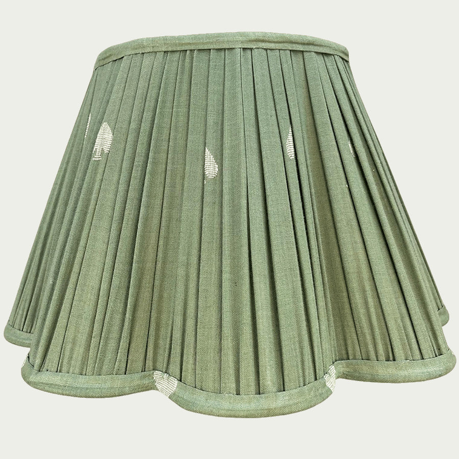 A soft sage green Jamdani lampshade woven with delicate white spade motifs