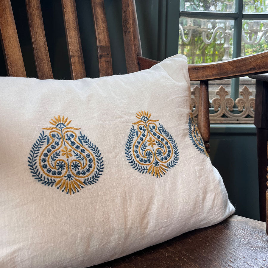 Kesar Chikankari cushion cover in off white with blue and mustard hand embroidery