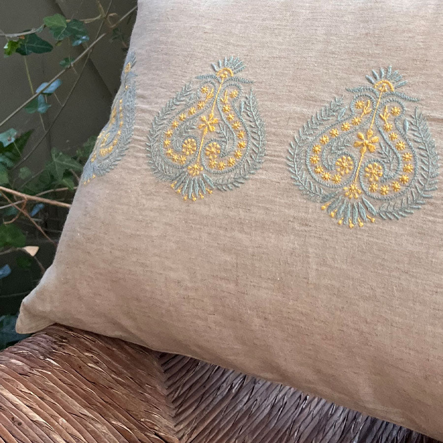 Close-up of Kesar Chikankari cushion cover in soft beige