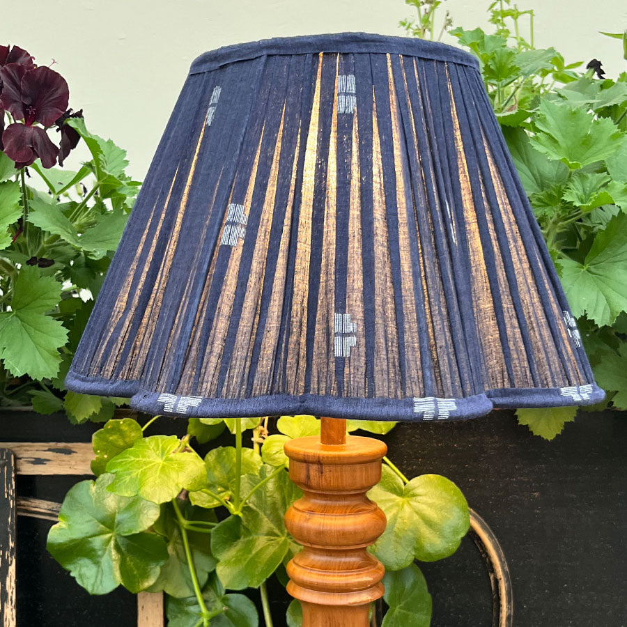 A rich navy Jamdani lampshade with crisp white motifs and a scalloped edge.