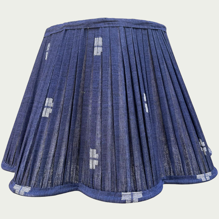 A rich navy Jamdani lampshade with crisp white motifs and a scalloped edge.
