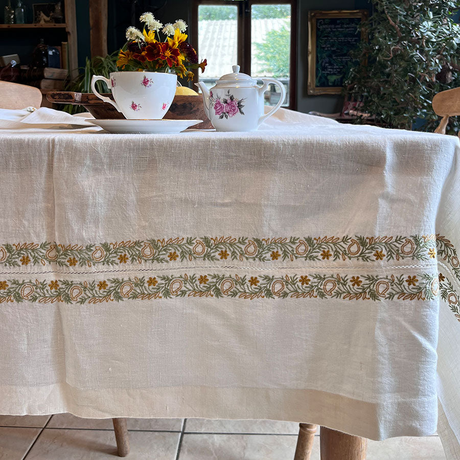 Baagh Chikankari tablecloth with hand embroidery on a table set with teacups and a teapot