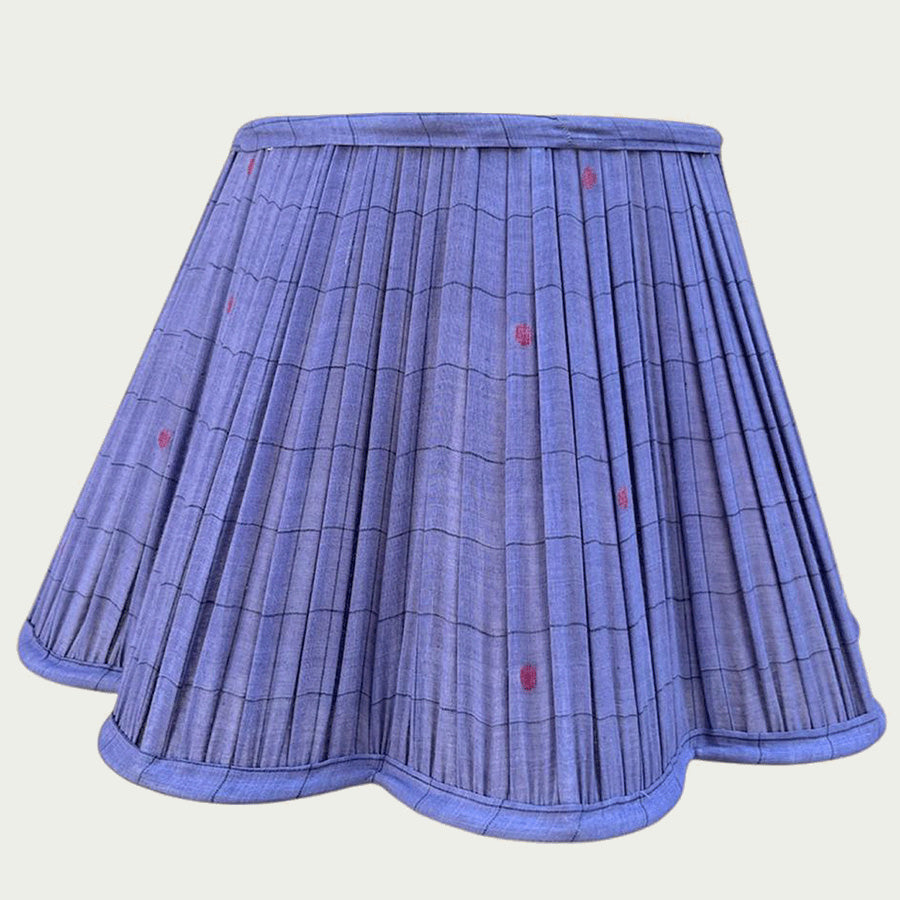 A deep blue Jamdani lampshade adorned with fine red motifs and scalloped edging.