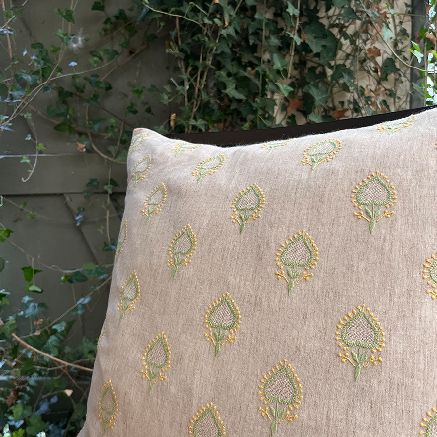 Close-up of Mogra Chikankari cushion cover with green and yellow hand embroidery