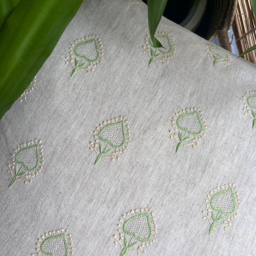 Mogra chikankari cushion cover with green and off-white embroidery on a natural linen fabric