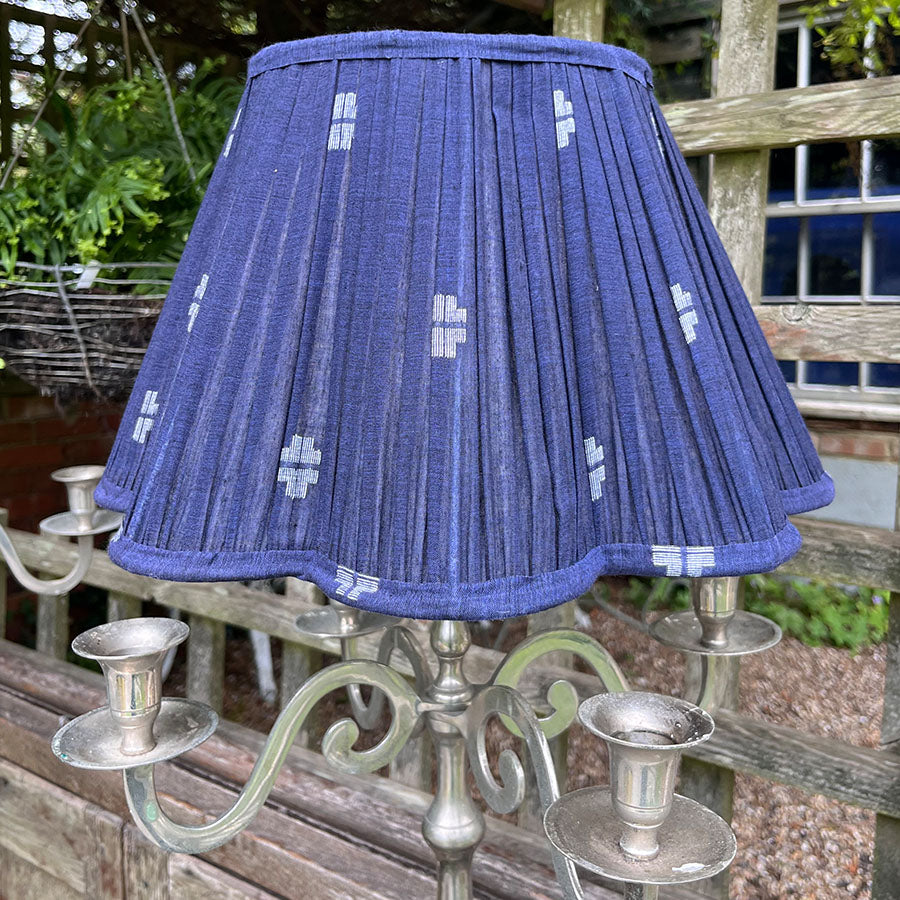 A rich navy Jamdani lampshade with crisp white motifs and a scalloped edge