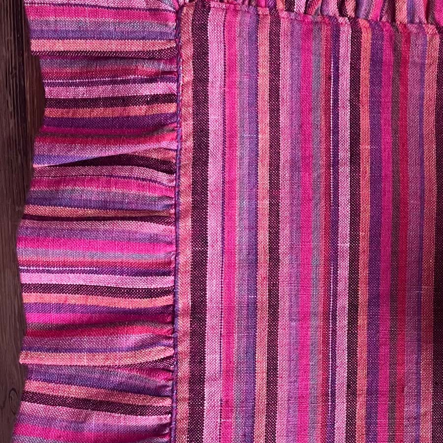 Close-up of pink striped placemats with ruffles
